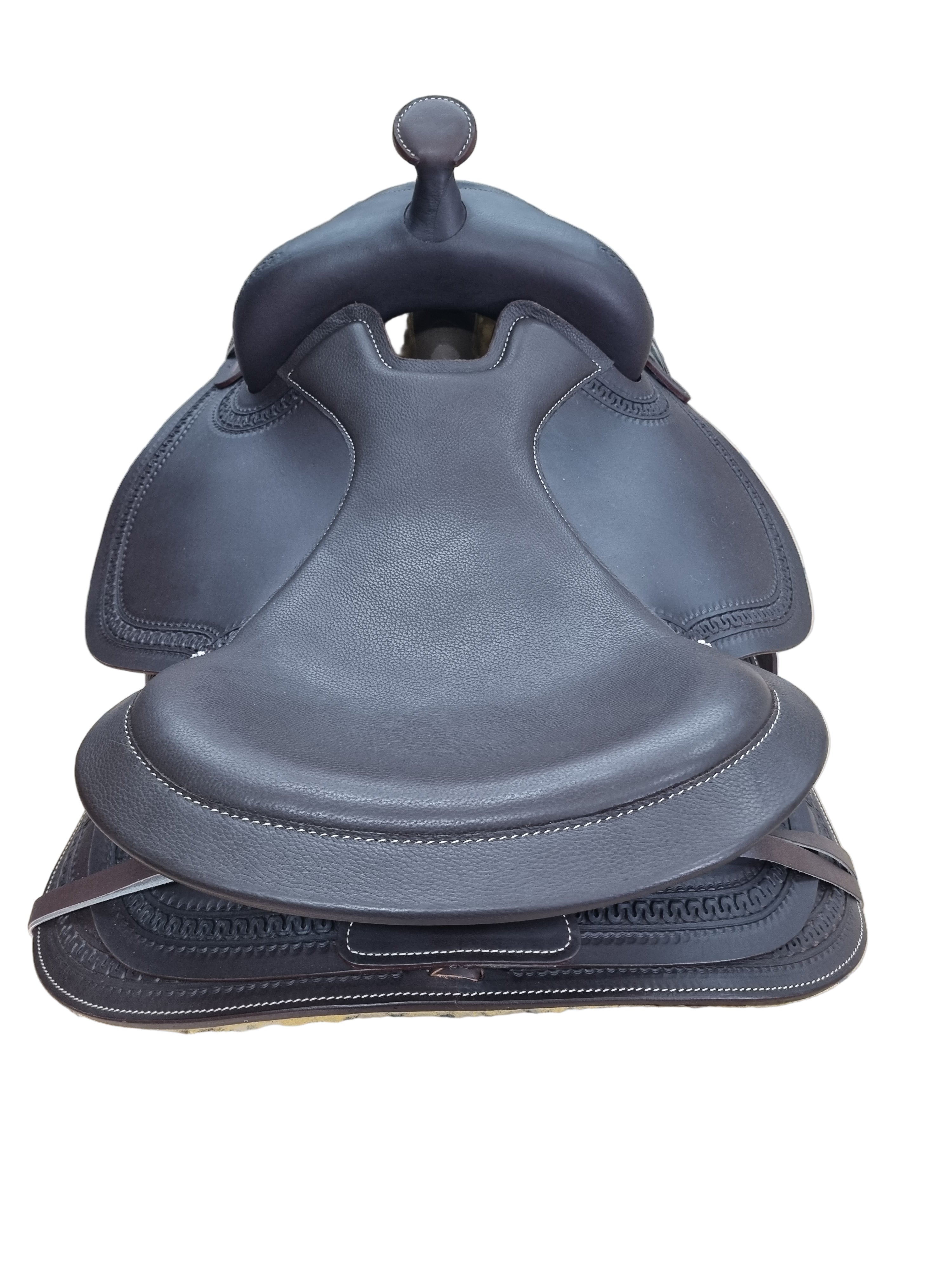 Gray leather saddle on a tiled wall
