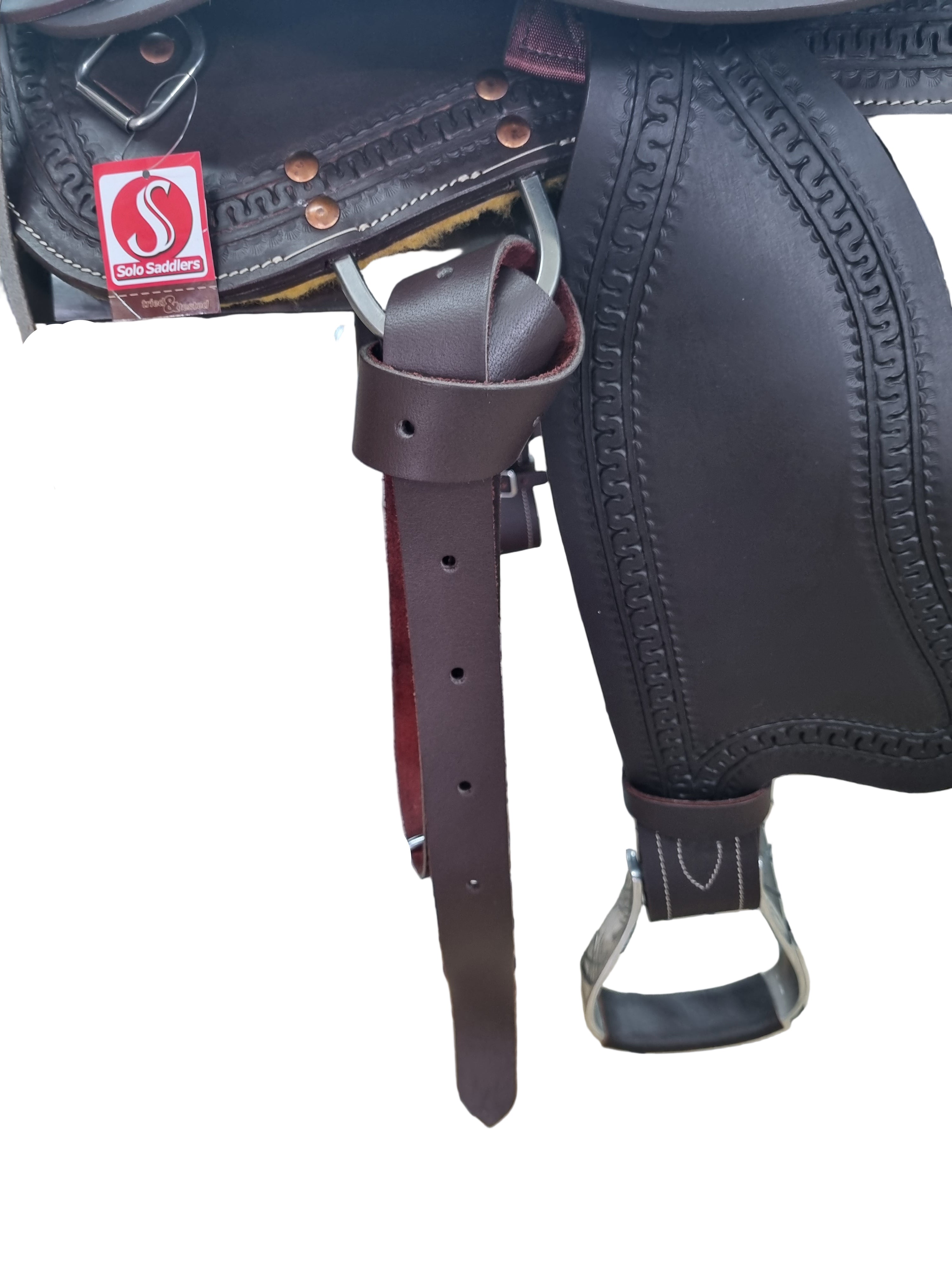 Close-up of a leather saddle with a brand label on a metal stand.