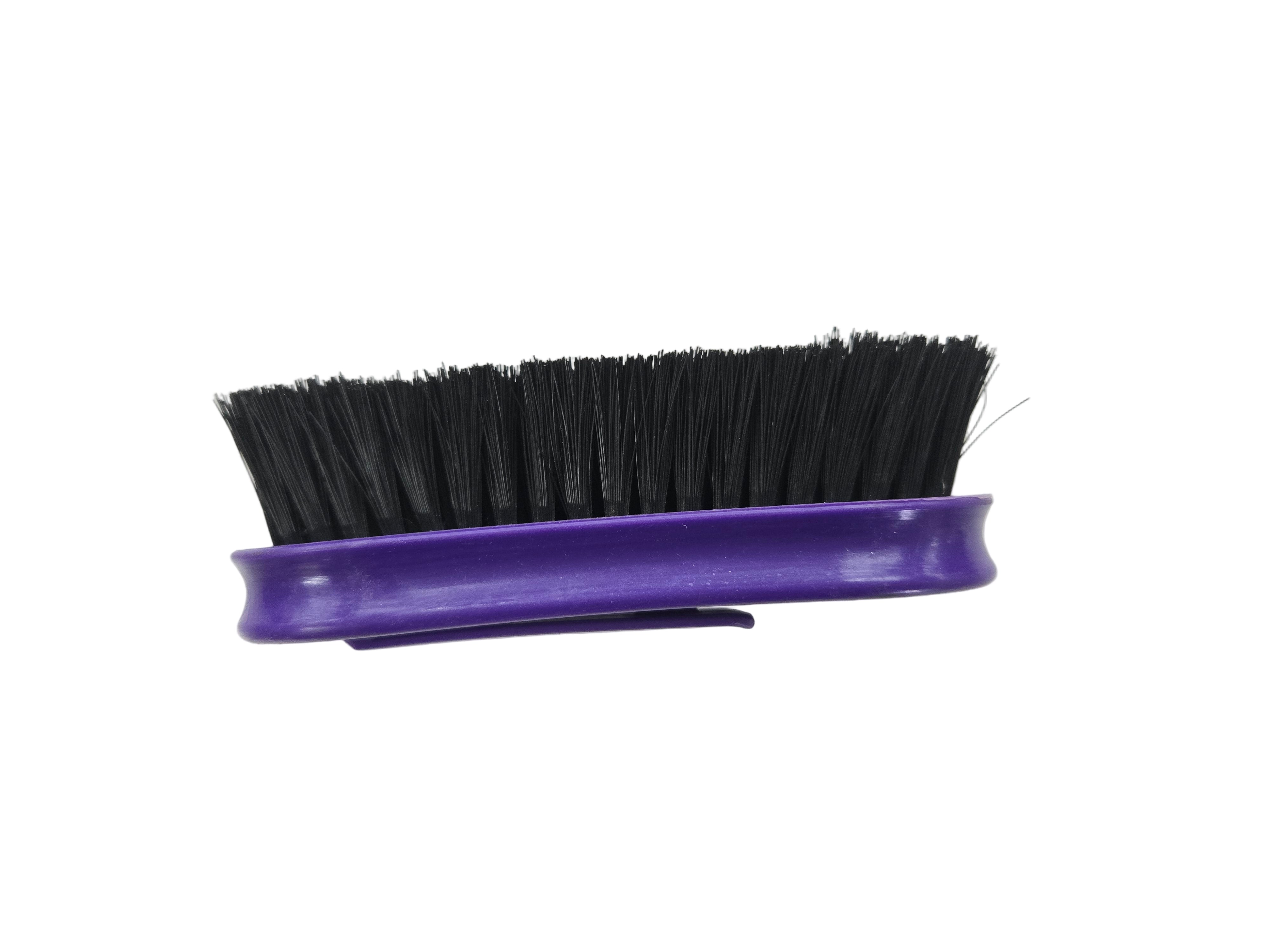 Purple brush with black bristles on a white background