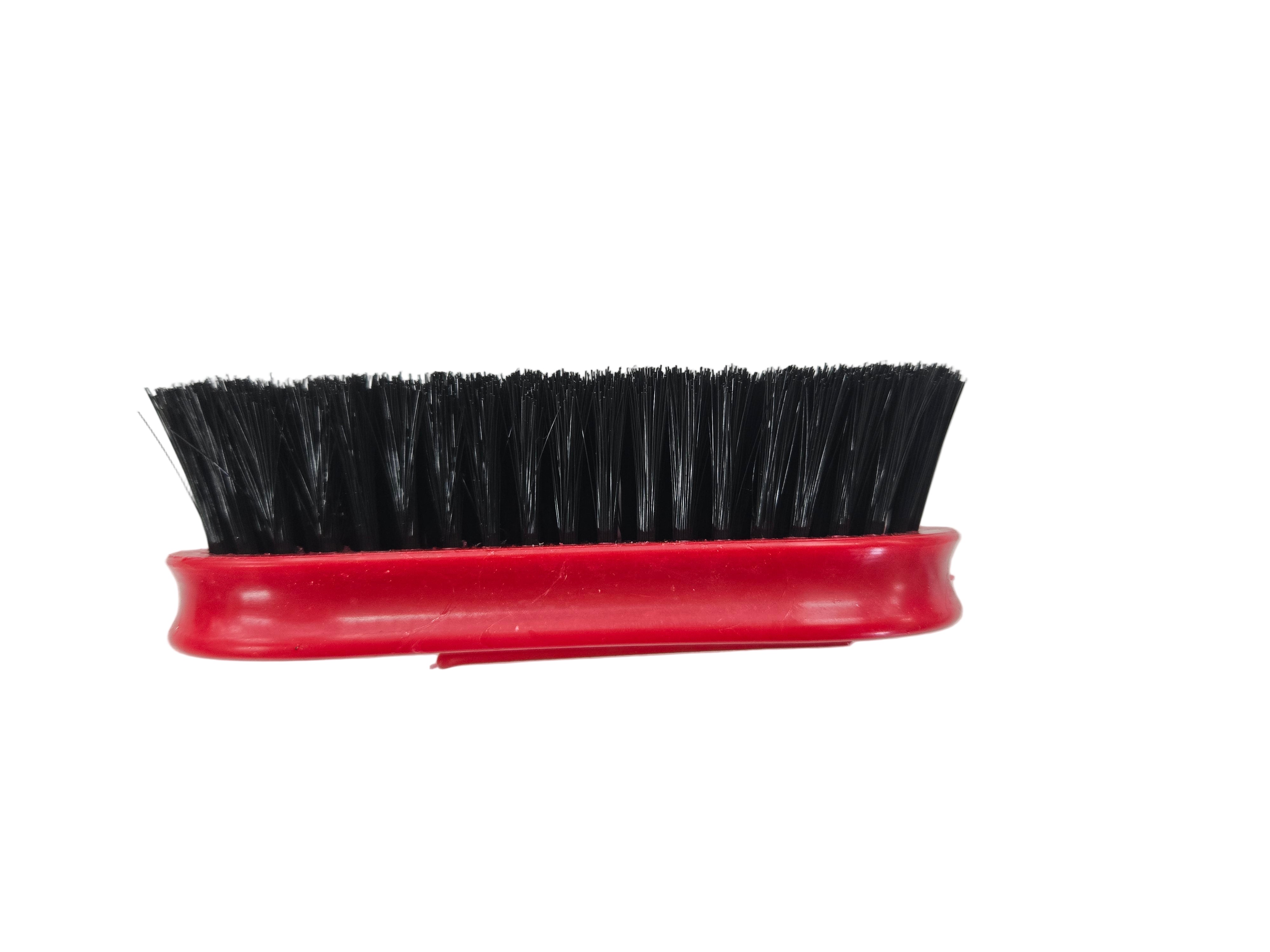 Red brush with black bristles on a white background