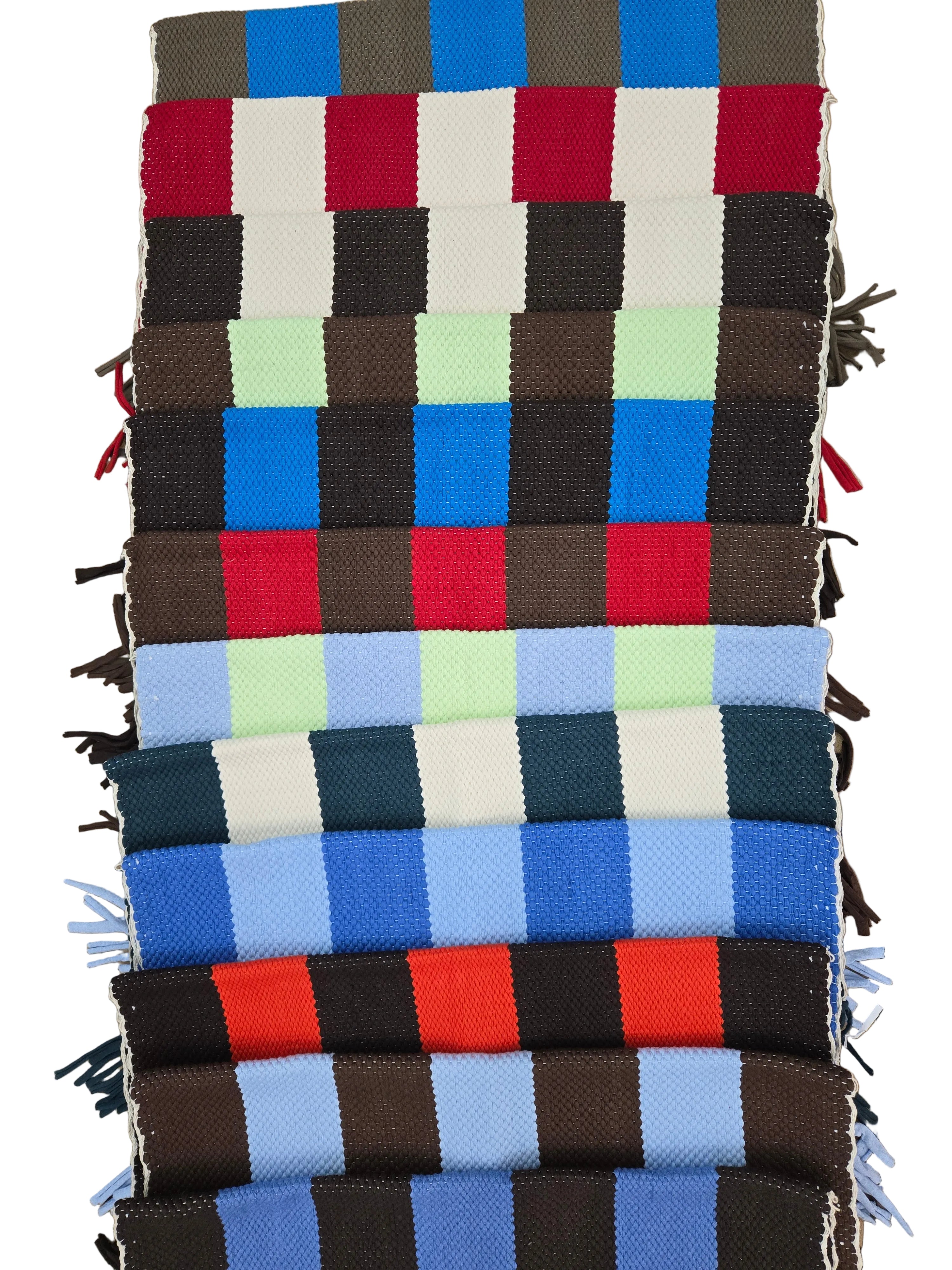 Woven textile with a checkered pattern on a tiled floor