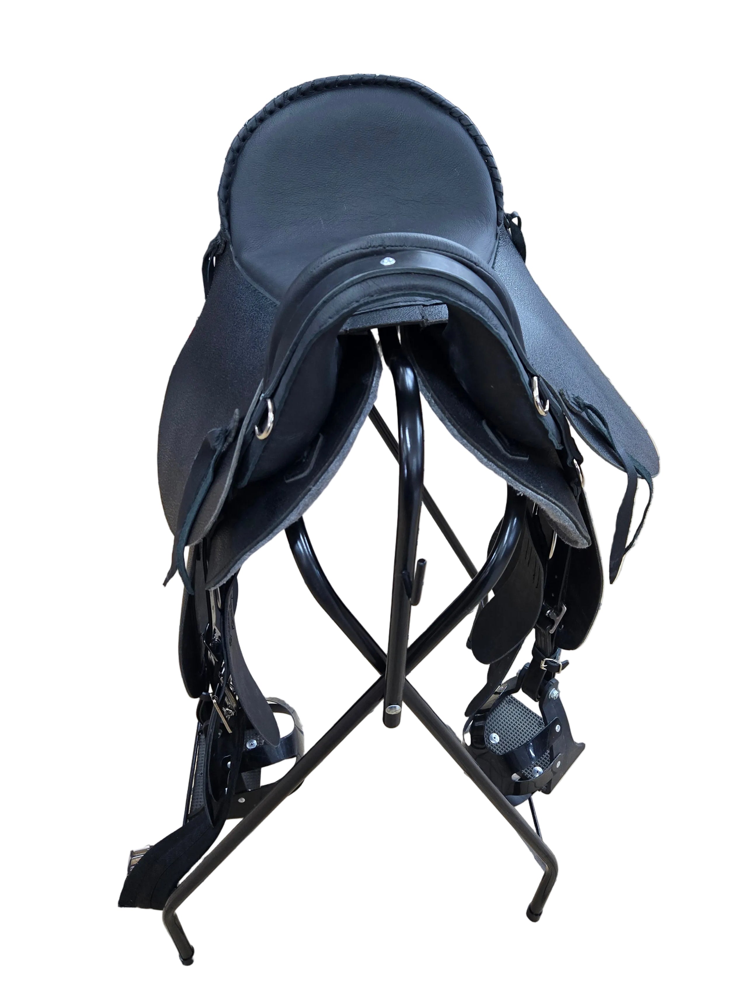 Horse saddle on a tiled floor with a warehouse background