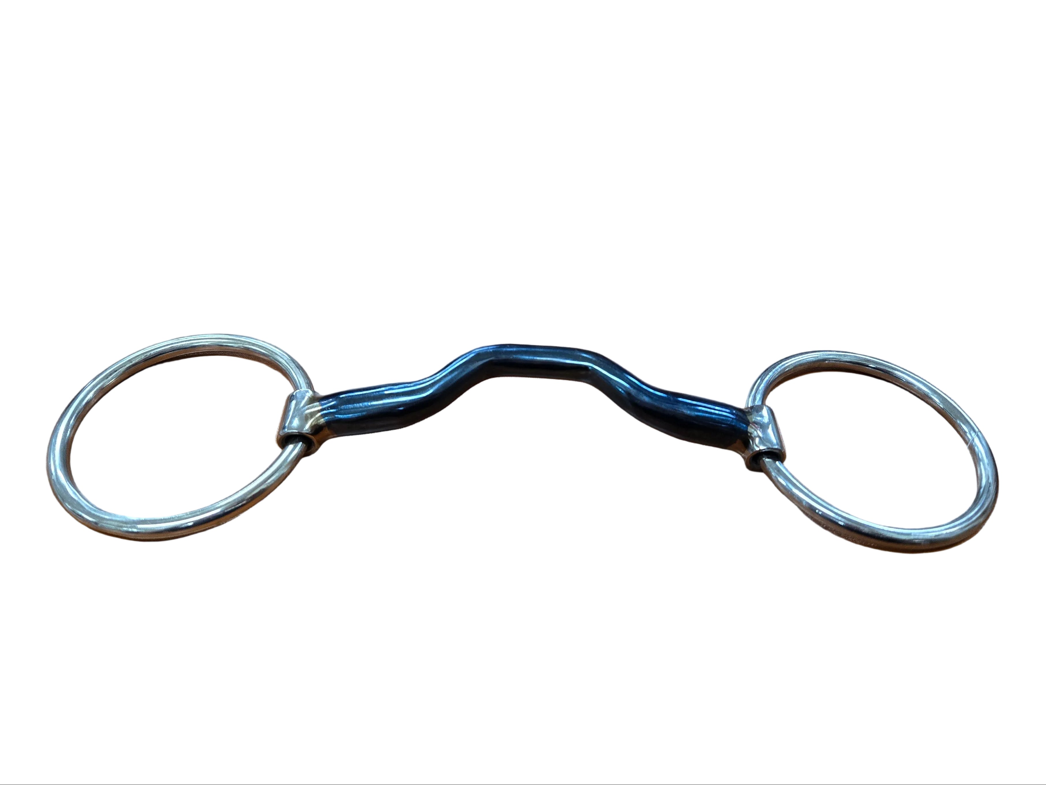 Metal snaffle bit on a wooden desk with a keyboard in the background
